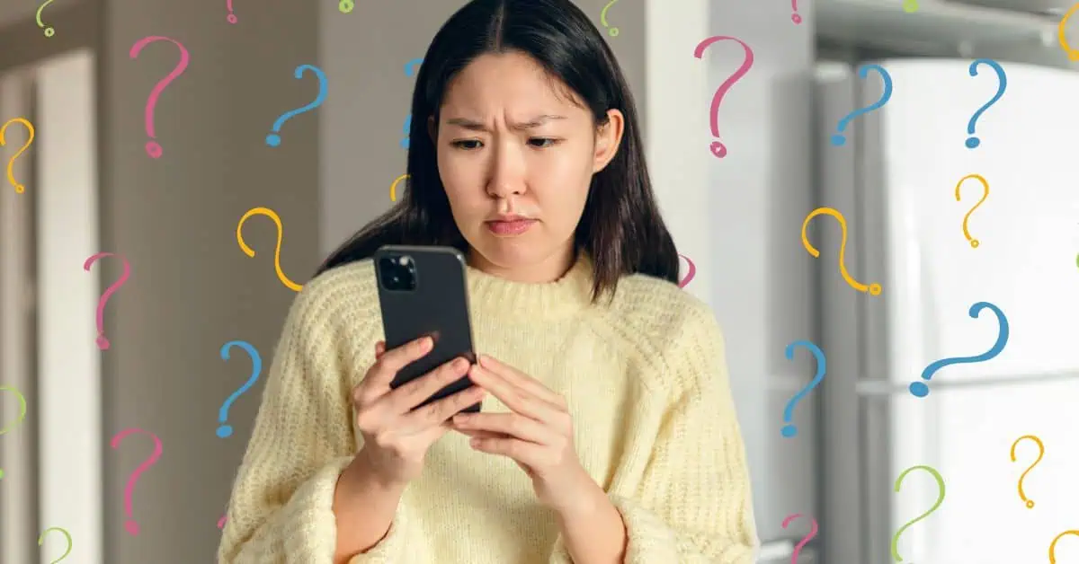 woman looking concerned at phone with question marks