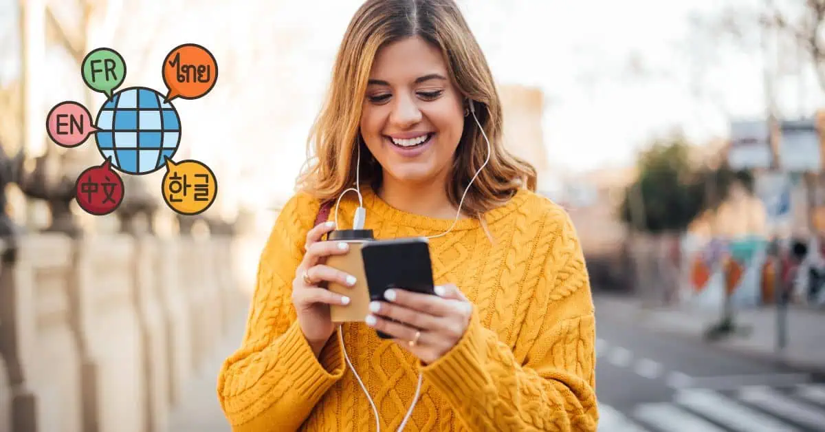 woman smiling looking at phone while holding coffee. With icon of globe and different languages around it