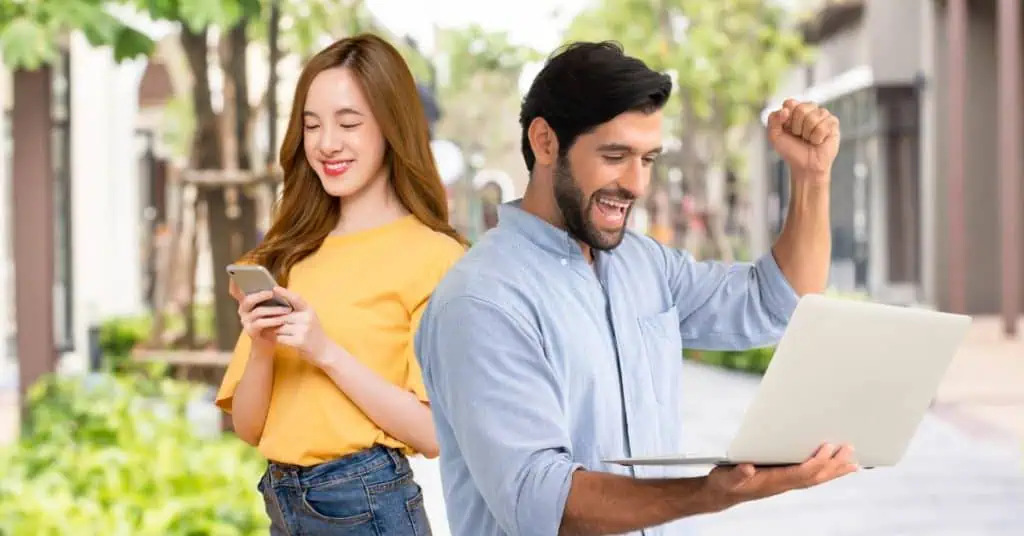 Happy Man and Woman Holding Electronic Devices