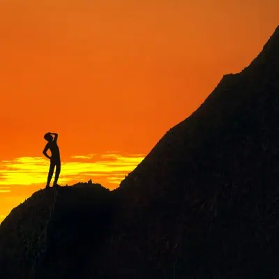 Life Challenges - Man Silhouette Looking up at the Top of a Mountain