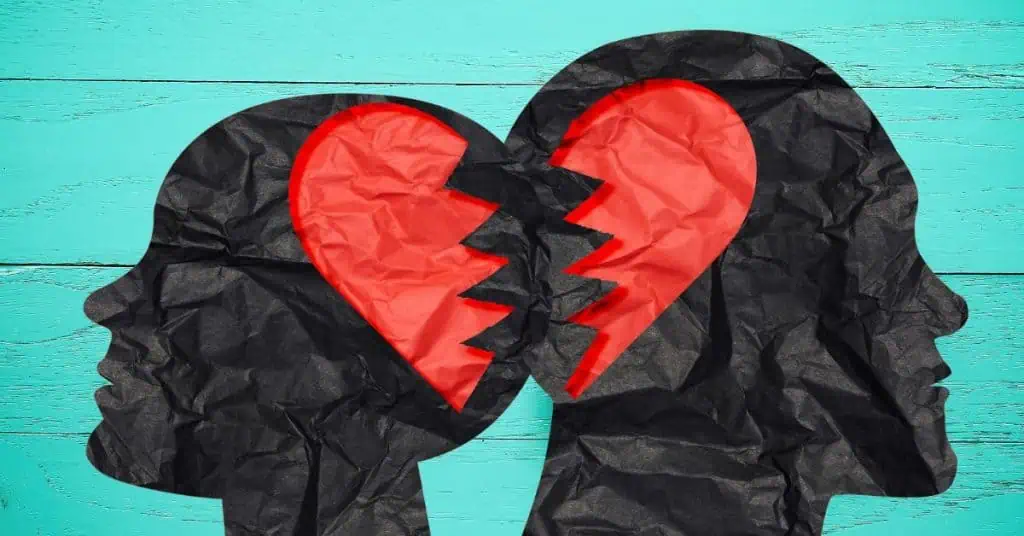 Paper Silhouettes of Female and Male Heads - Red Heart Cut in Half