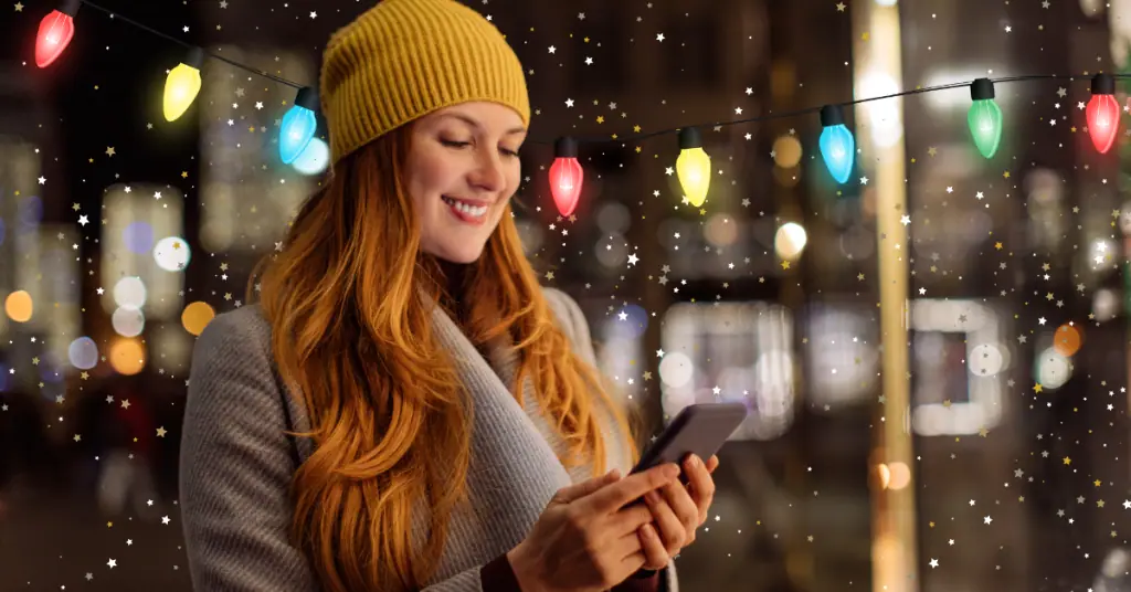 woman looking at phone during the holidays