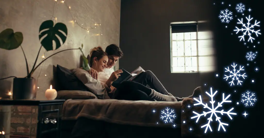 man and woman in bed with snowflakes